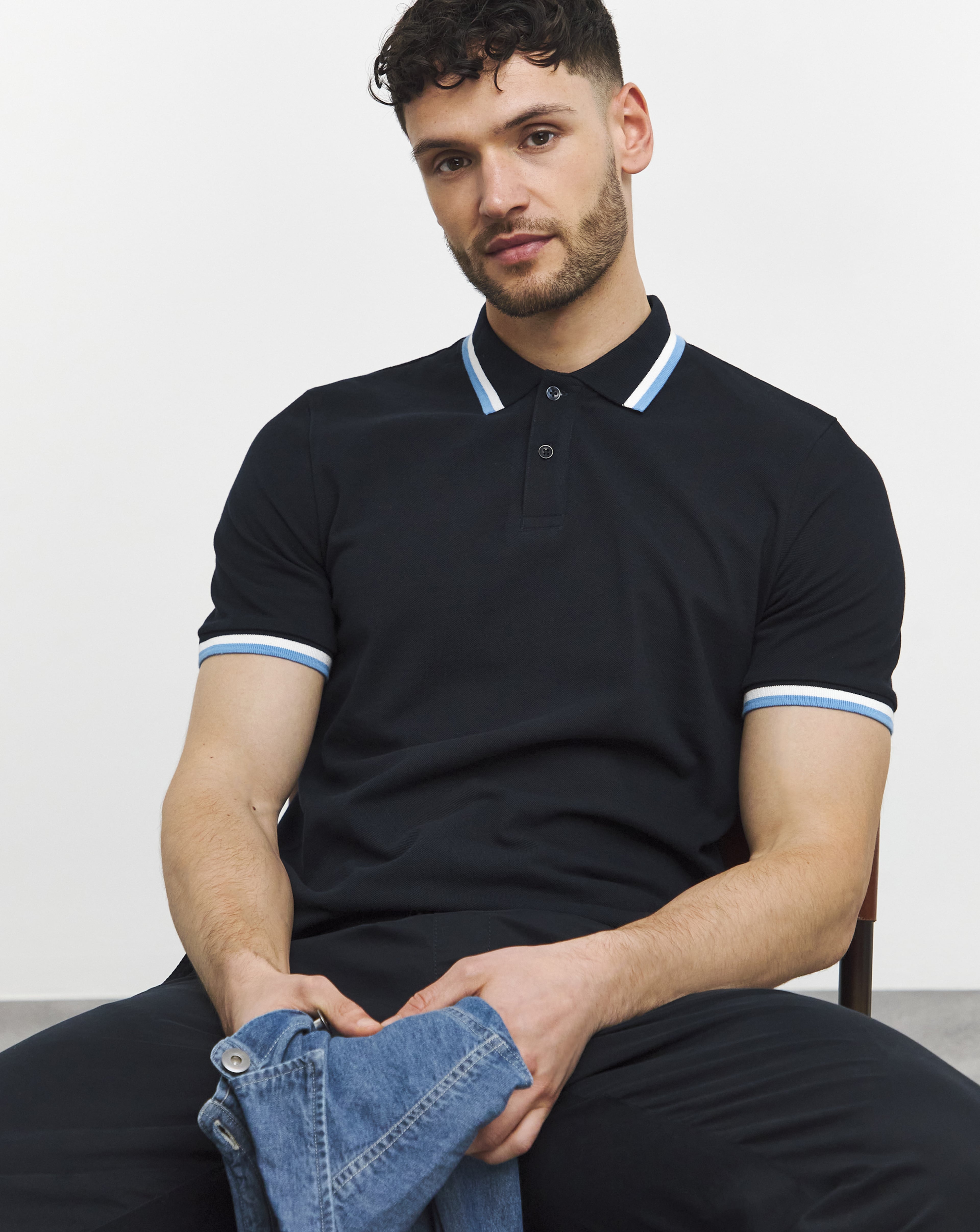 A man wearing a dark blue polo shirt